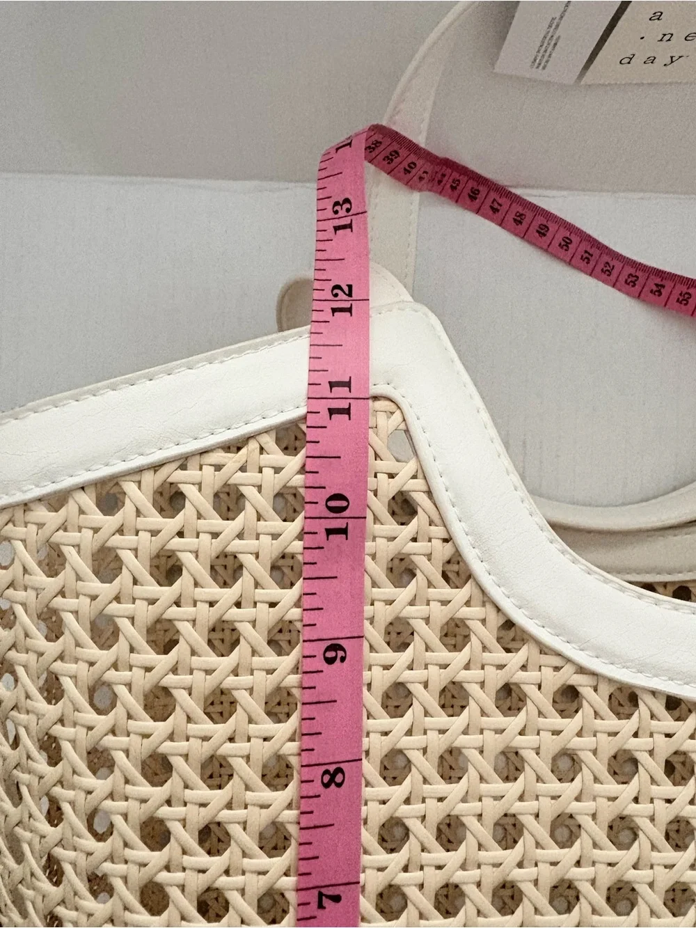 A New Day Straw Caning Tote Bag natural woven cane design white trim detailing.